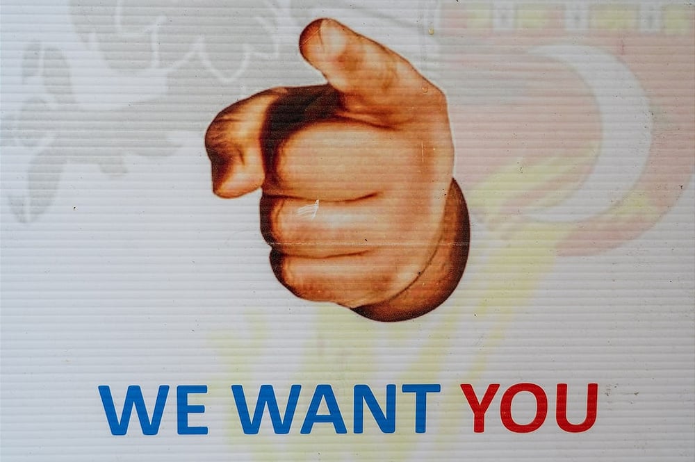A sign saying we want you, requesting people to join a club.