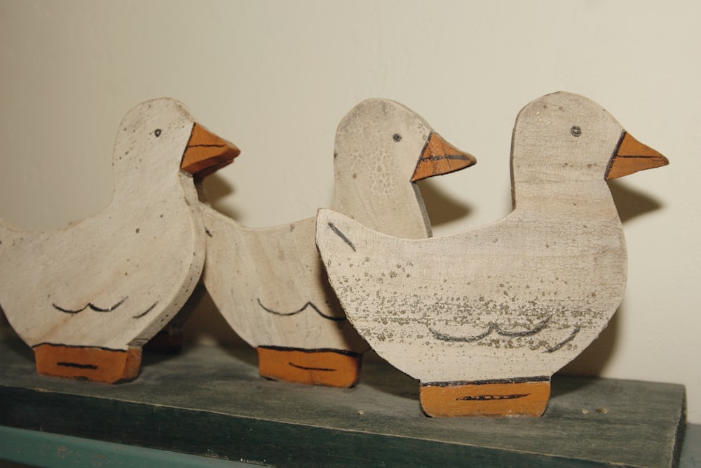 A trio of three hand painted wooden ducks sit in a row as vintage home decor in a bed and breakfast in Door County, Wisconsin.