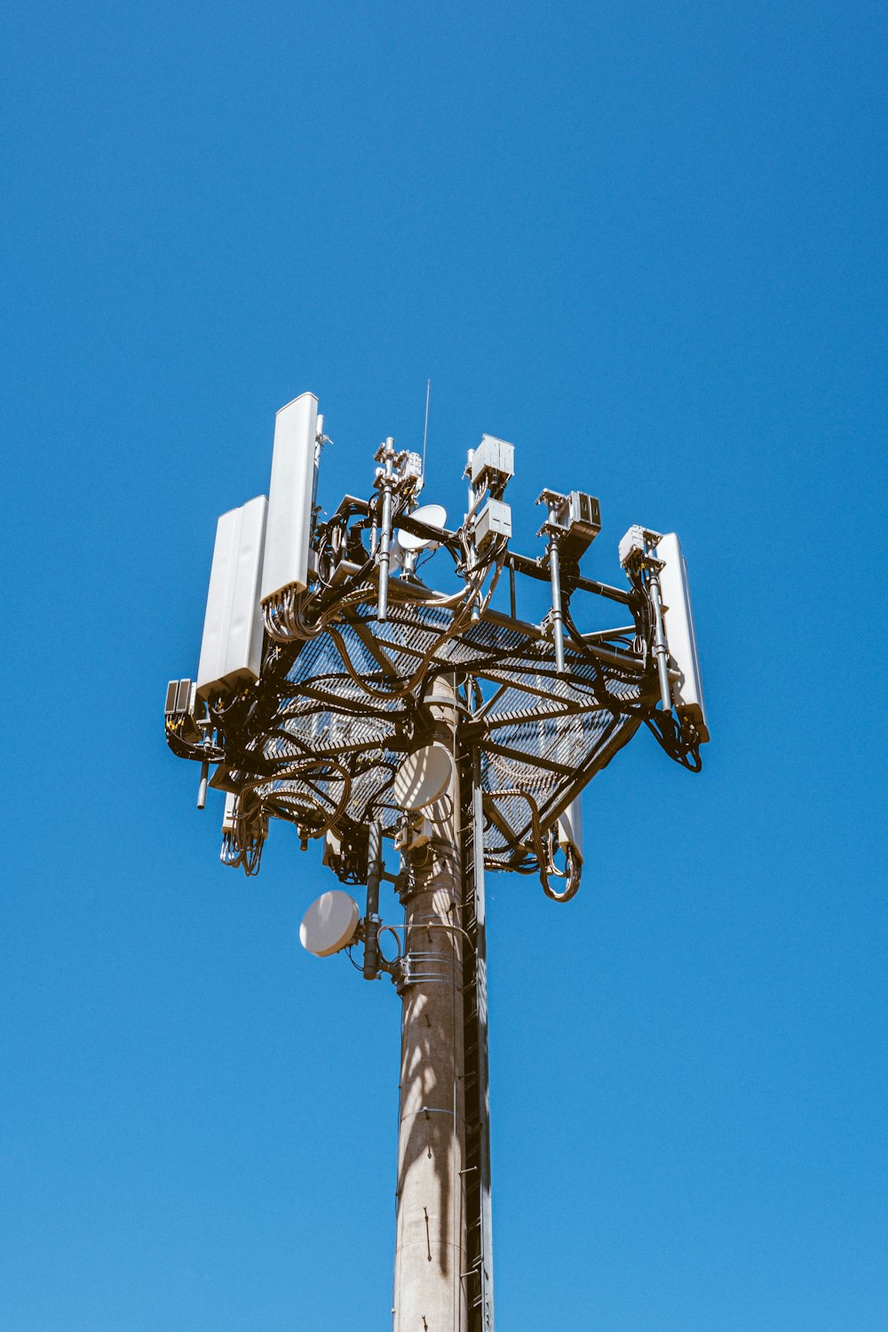 A telecom tower against a blue sky.