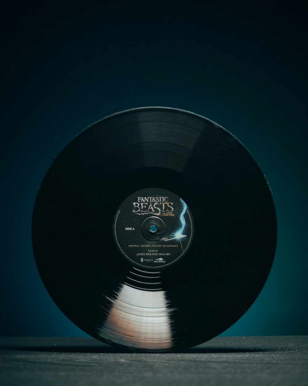 black vinyl record on blue surface