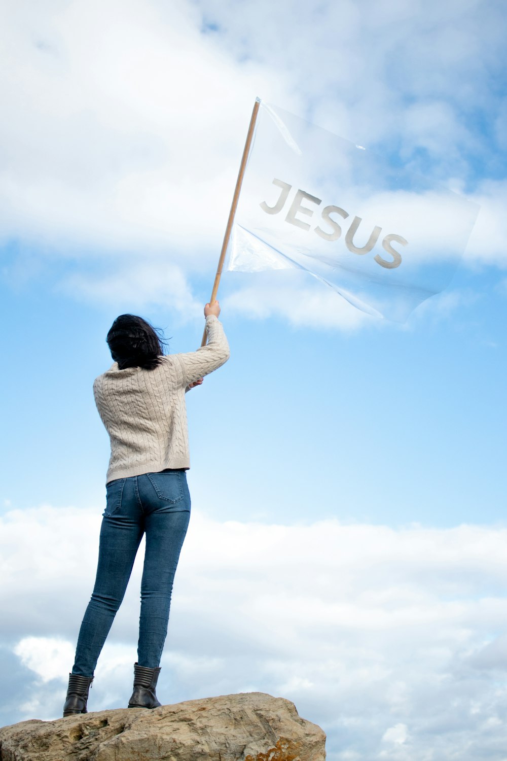Woman holding a flag with the word 