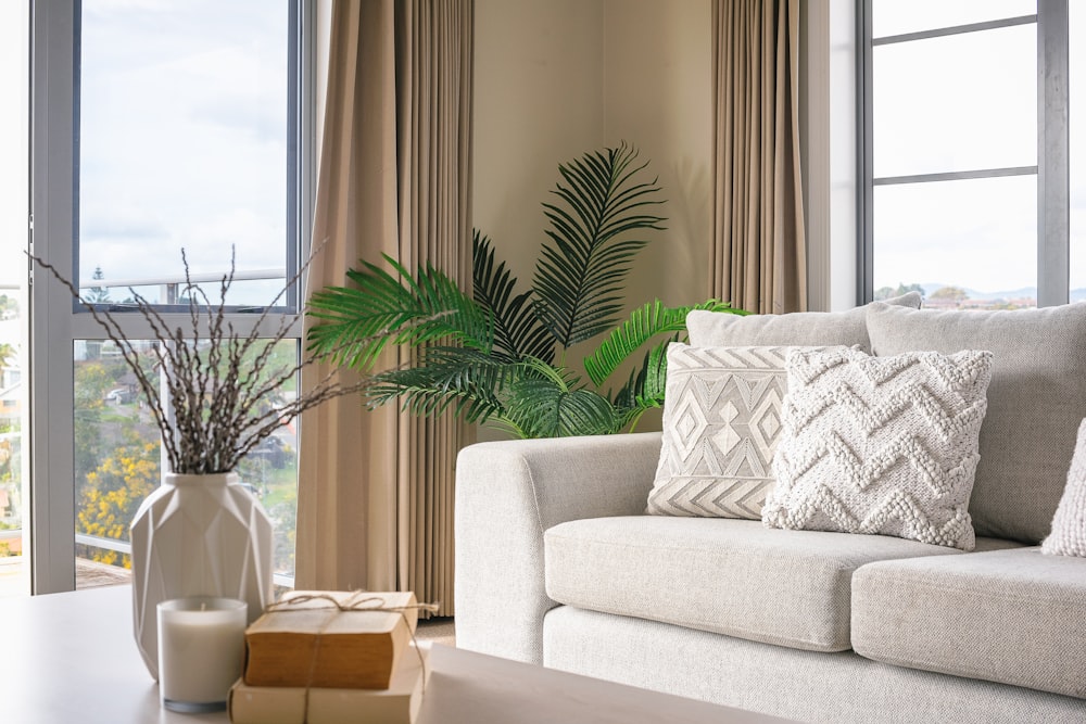 White Couch In living Room With Coffee Table Curtains And Windows