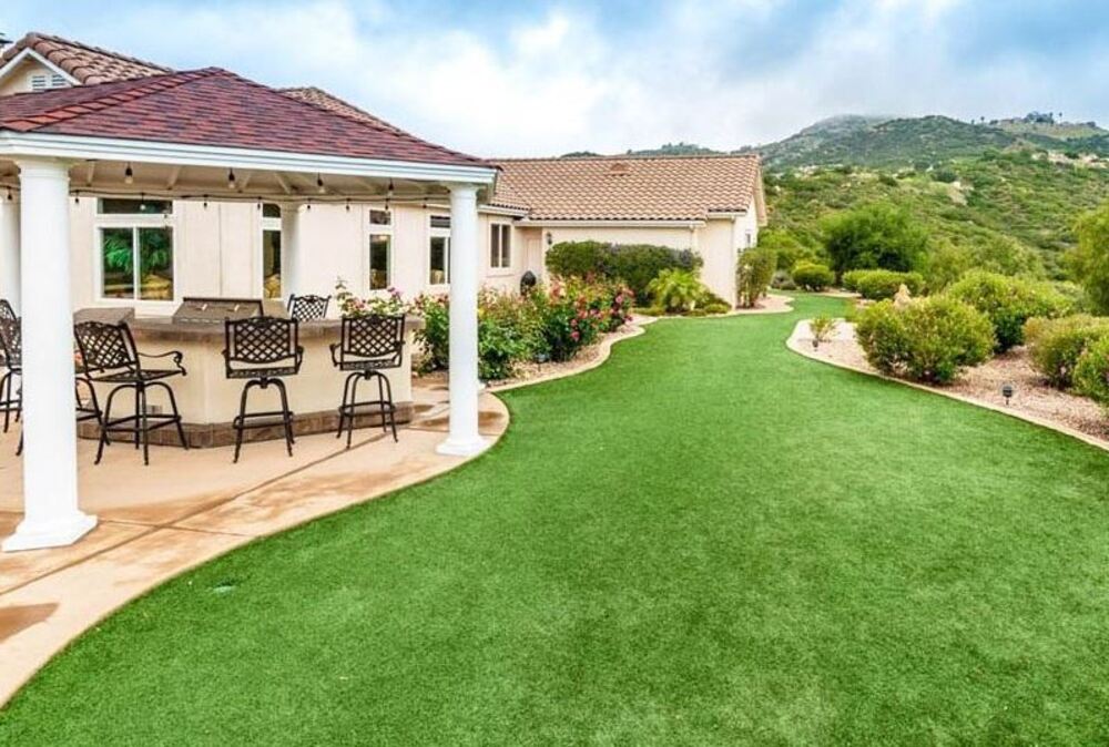 backyard with patio scenery of mountains and artificial turf